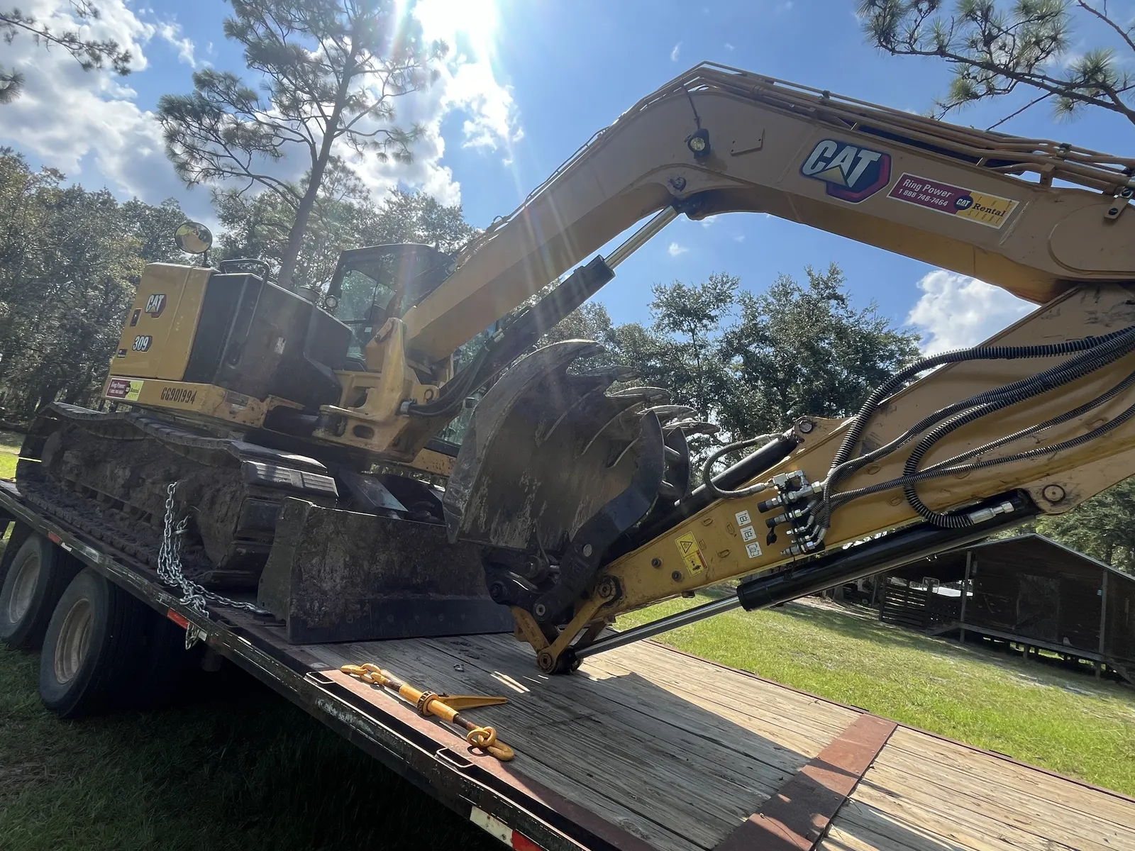 Our compact excavator with the mulching head mounted, loaded on the gooseneck trailer
